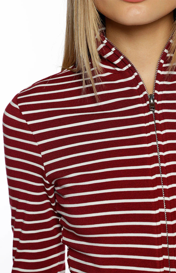 Close-up of the burgundy and white striped sweater with a silver zipper detail on the high neck