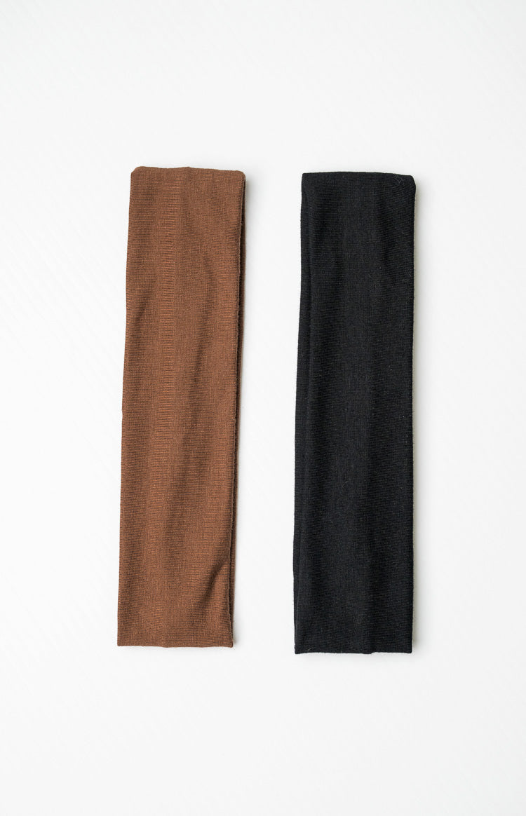 Two wide headbands, one in a soft brown ribbed knit and the other in a black ribbed knit fabric
