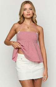 White denim low-rise mini skirt with a frayed raw hem and subtle distressed details on the pockets