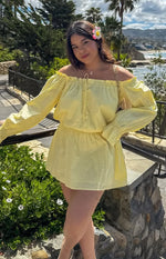 Yellow Bardot mini dress with off-shoulder ruffled neckline, long puff sleeves, elasticated waist, and flowy skirt