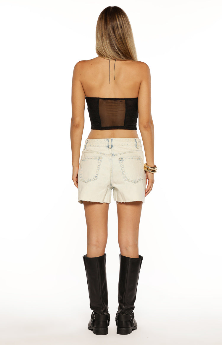Back view of a black strapless mesh corset top with a large sheer mesh panel