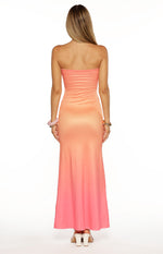 Back view of the strapless maxi dress, showing the smooth fabric and pink ombre effect from peach to coral