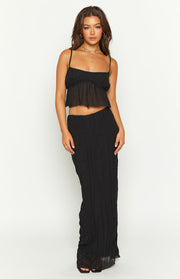 Front view of a black maxi skirt with a textured crinkled fabric and sheer hem