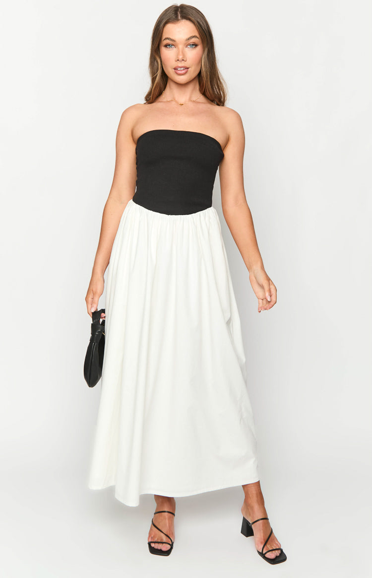 Front view of a black strapless maxi dress with a fitted black bodice and a contrasting white gathered full skirt