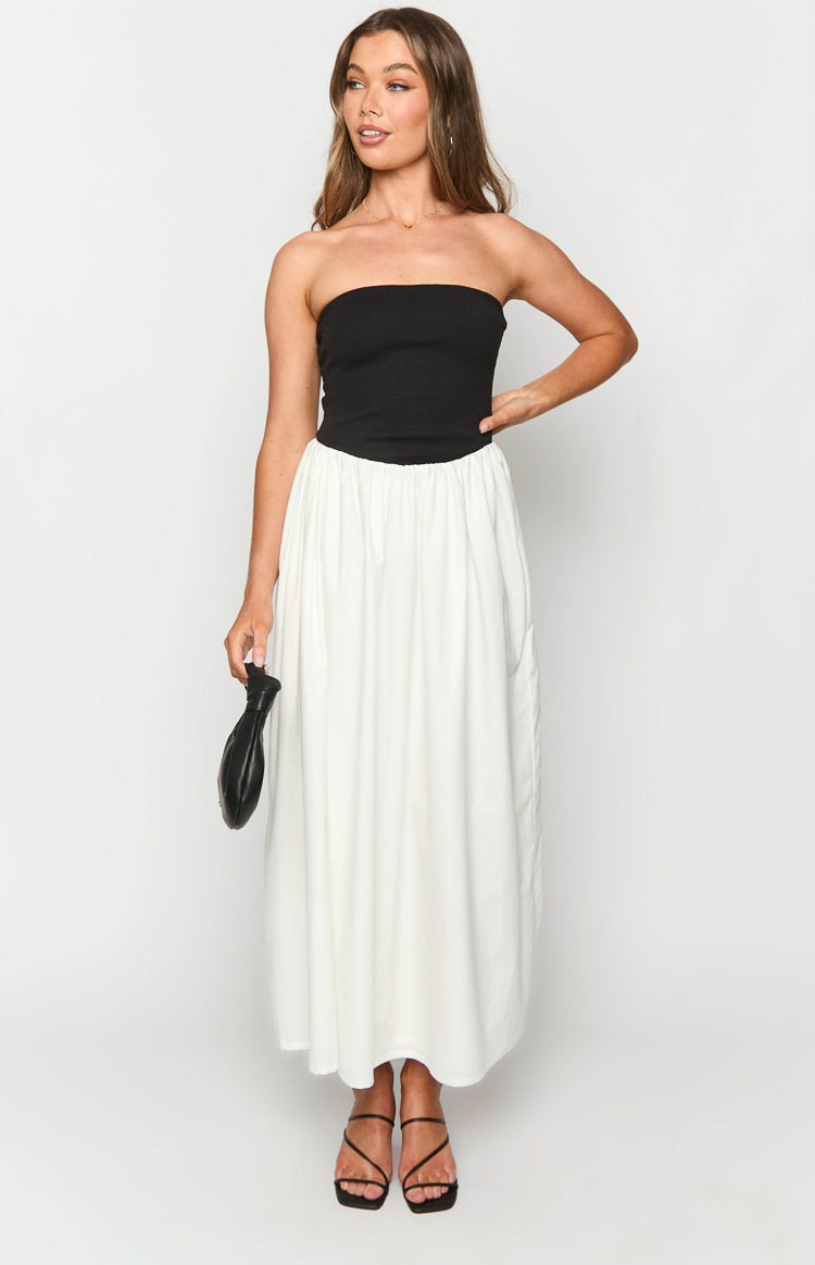 Front view of a black strapless bodice with a gathered white flowy maxi skirt