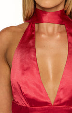 Close-up of the red satin deep V-neckline and halter scarf detail of the mini dress